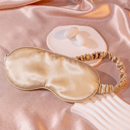 SILKAVA silk sleep mask on silk fabric background, champagne
