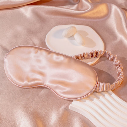 SILKAVA silk sleep mask on silk fabric background, pink