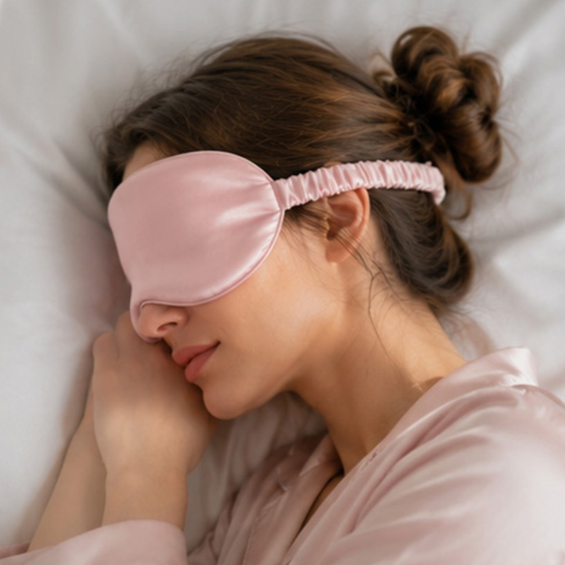Woman wearing SILKAVA silk sleep mask, pink