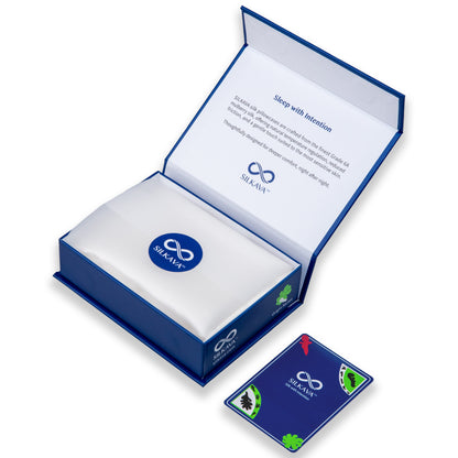 SILKAVA silk pillowcase in packaging with tissue paper, alongside Origin Series collectible card, white